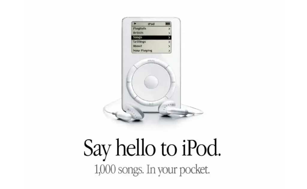 A classic iPod with white earbuds against a white background. Text below reads: "Say hello to iPod. 1,000 songs. In your pocket."
